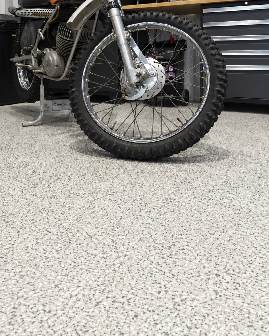 Taller de motocicletas con piso epóxico de hojuela clara (imagen de referencia)